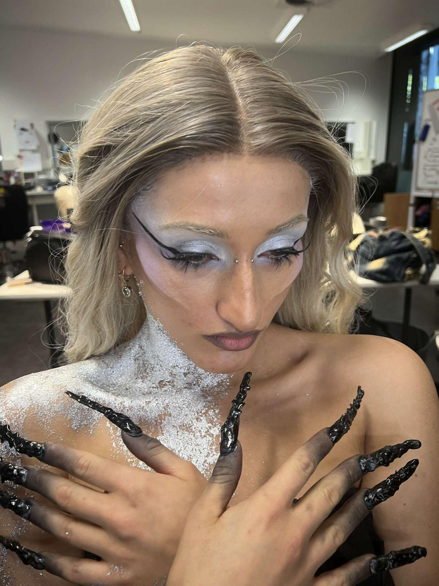 Music video glam with silver glitter and graphic eyeliner